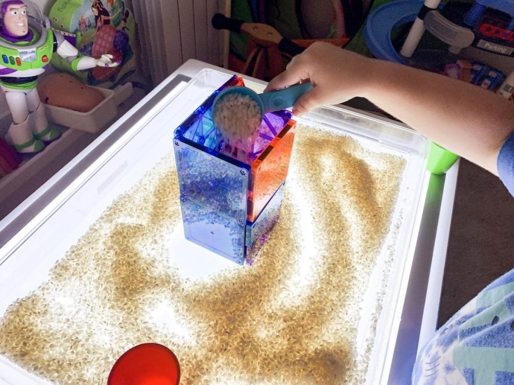 light table play rice and magnetic tiles